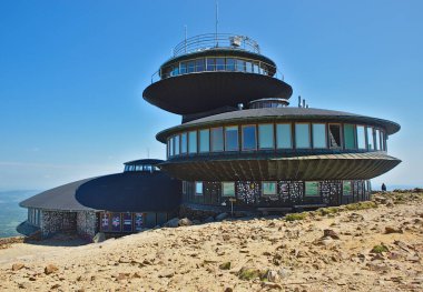 Giant Mountains, Poland - May 29 2023: Sign and observatory buildings at peak of Sniezka mountain. clipart