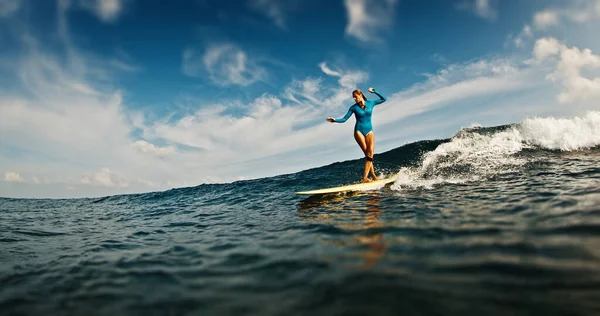 スリムな女性サーファーが波に乗っています 女性は黄色のロングボード上のモルディブの海の波をサーフィン — ストック写真
