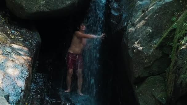 Young Man Takes Shower Refreshes Himself Waterfall — Stock Video