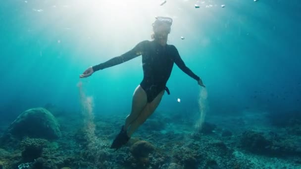 解放された女性が上昇します 若い女性の解放された川は水中で泳ぎ 砂で遊ぶ 水中のトレース — ストック動画