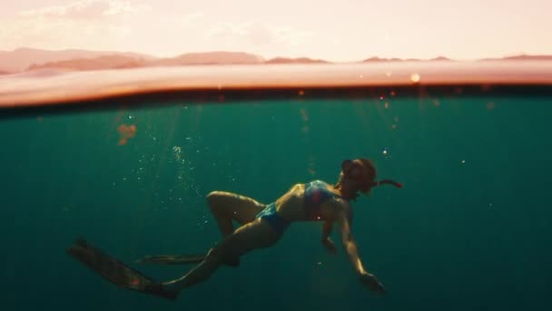 Woman Freediver Swims Underwater Sea Sunset Relaxes Floats Surface — Stock Video