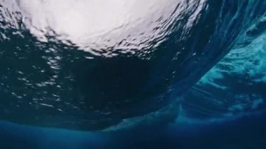 Resifin üzerinden okyanus dalgasının sualtı görüntüsü geçiyor.
