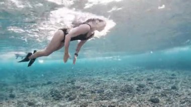 Genç, sıska kadın daldı dalgaların altına