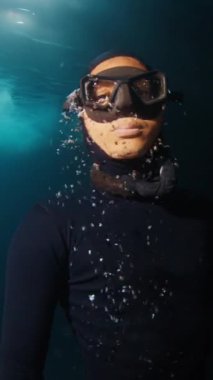Kapatın Freediver portresi karanlık sualtı mağarasını keşfediyor ve yüzeye çıkıyor.