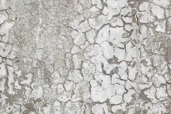 Old Plaster Wall With Dirty White Black Scratched Horizontal Background. Cracked concrete old wall texture background. Retro Vintage Worn Wall Wallpaper. Decayed Cracked Rough Abstract Banner Surface