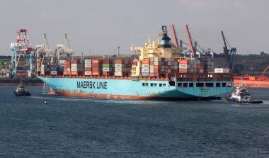 Odessa, Ukraine -2021: Logistics terminal shipment of import-export cargo containers on cargo ship in seaport. Industrial landscape with gantry cranes loading ship at piers of Odessa port, Yuzhny port