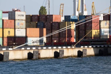 Odessa, Ukraine-202: Logistics terminal sends import-export cargo containers to cargo ship in seaport. Industrial landscape with gantry cranes loading ship at berths of Odessa port, port of Ilyichevsk