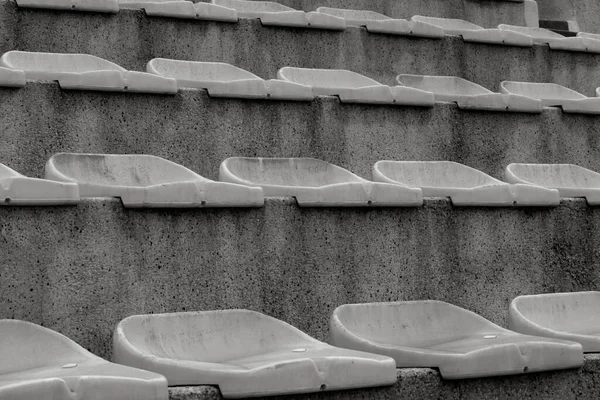 Vintage sports background seats in a small provincial stadium. Background of empty seats on the steps of the stands for football fans