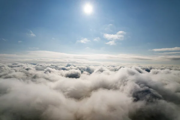Atmosphere of flying above clouds. Sky thunderclouds, horizon line from an airplane drone. Creative background for design. Dawn, sun over clouds - positive travel concept of meditative joy of future