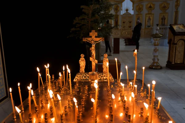 Panakhida, Easter, funeral liturgy in the Orthodox Church. Christians light candles in front of an Orthodox cross with a crucifix and sacrificial bread. The concept of the Orthodox faith and religion