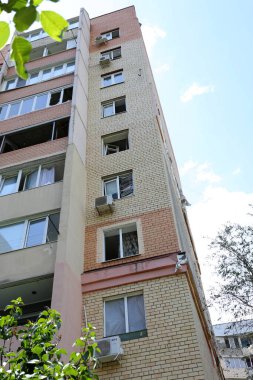 ODESSA, UKRAINE - 10 Haziran 2023 Ukrayna ve Rusya Savaşı. Bir top mermisi binanın avlusuna uçtu. Sivil evin oyun parkında roket patlaması sonucu hasar görmüş ön cephe ve kırık pencereler.