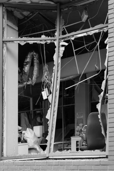 Stock image Broken windows of civilian building of bomb explosion. Shards of glass stick out dangerously in window frame. War between Ukraine and Russia. Broken civilian windows by explosion and rocket fragments