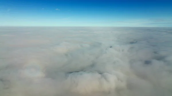 CFlying high above the clouds. Aerial view of clouds and horizon from drone. Thunderclouds from above before rain. Tragic gloomy natural landscape of horihonta at bird\'s eye view