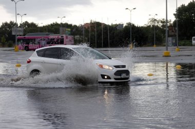 ODESSA, UKRAINE-5 Eylül 2024: Şiddetli yağmurlar, yollarda oluşan trafik sıkışıklıkları sonrasında, arabalar suyla ve duraklamayla dolup taşıyor. Arabalar yollardaki su birikintilerinde yüzer, su sıçratır. Şiddetli yağmurdan sonra yol çöktü