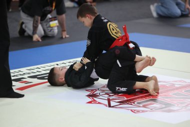 ODESSA, UKRAINE - 6 Nisan 2025: Ukrayna ulusal yarışmacı jiu jitsu genç sporcuları yoğun dövüşler düzenliyor, şampiyonluk için tatamiyle mücadele ediyorlar