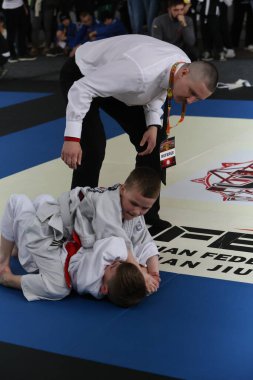 ODESSA, UKRAINE - 6 Nisan 2025: Ukrayna ulusal yarışmacı jiu jitsu genç sporcuları yoğun dövüşler düzenliyor, şampiyonluk için tatamiyle mücadele ediyorlar