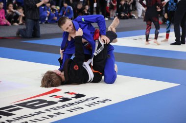 ODESSA, UKRAINE - 6 Nisan 2025: Ukrayna ulusal yarışmacı jiu jitsu genç sporcuları yoğun dövüşler düzenliyor, şampiyonluk için tatamiyle mücadele ediyorlar