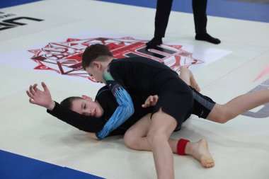 ODESSA, UKRAINE - 6 Nisan 2025: Ukrayna ulusal yarışmacı jiu jitsu genç sporcuları yoğun dövüşler düzenliyor, şampiyonluk için tatamiyle mücadele ediyorlar