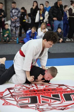 ODESSA, UKRAINE - 6 Nisan 2025: Ukrayna ulusal yarışmacı jiu jitsu genç sporcuları yoğun dövüşler düzenliyor, şampiyonluk için tatamiyle mücadele ediyorlar