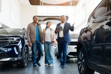 Otomobil satıcısı galeride Oto Seçen Lüks Araba Danışmanı Çifti Gösteriyor. Araç Konsepti satın alınıyor. Yüksek kalite fotoğraf