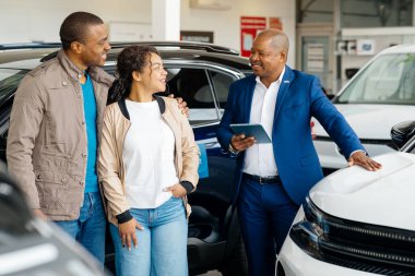 Genç bir Afro-Amerikan çift, yeni araba alımlarını satış müdürüyle aktif olarak tartışıyor. Anlaşmalarını sonuçlandırma sürecinde mutlu ve meşgul görünüyorlar..