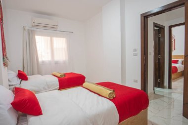 Interior design decor furnishing of luxury show home bedroom showing furniture and twin single beds in resort