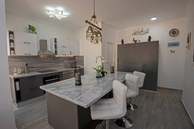 Interior design decor showing modern kitchen and appliances in luxury apartment showroom with bedroom