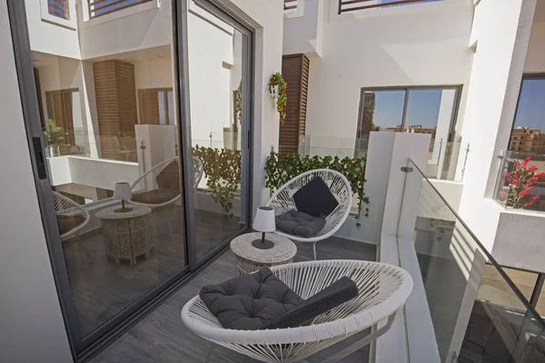 Terrace furniture of a luxury apartment in tropical resort with table and chairs on balcony