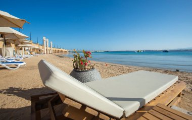 Landscape view over ocean from tropical hotel resort beach with sun loungers