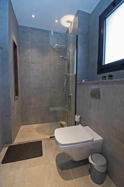 Interior design of a luxury show home bathroom with shower cubicle and floating toilet