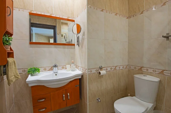 Interior design of a luxury show home apartment bathroom with wooden unit and sink