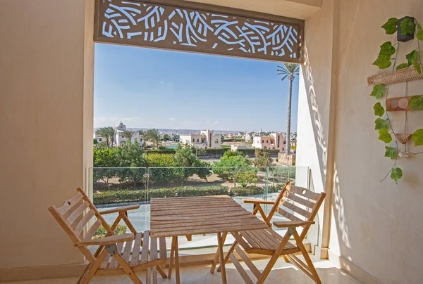 Terrace furniture of a luxury apartment in tropical resort with furniture and garden view from balcony