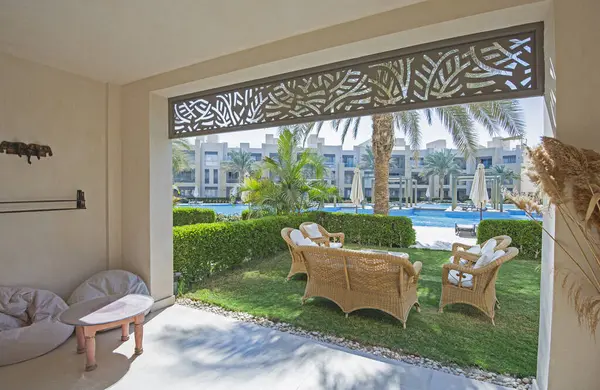 Garden terrace furniture of a luxury apartment in tropical resort with furniture and pool view