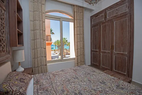 Interior design decor furnishing of luxury show home bedroom showing furniture and double bed with tropical sea view