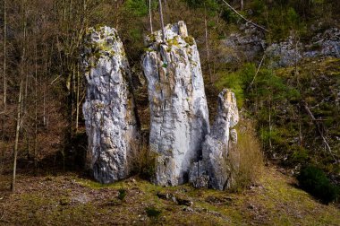 Rock formation in the Moravian Karts called Father Mother and Son. South Moravia, Czech Republic. clipart