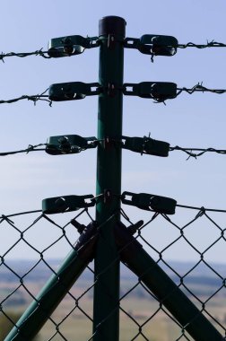 Close-up view of fencing that is made of steel wire. A device that prevents the entry of strangers and animals. clipart