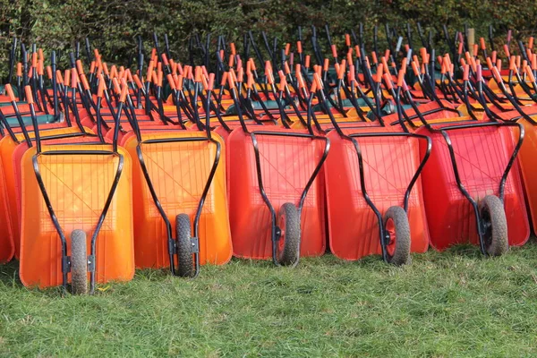 Large Collection Orange Plastic Garden Wheelbarrows — Stock Photo, Image