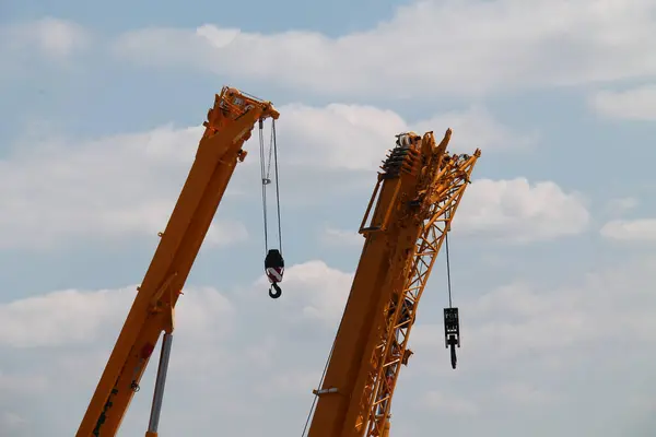 stock image The Jibs of Two Large Hydraulic Construction Cranes.