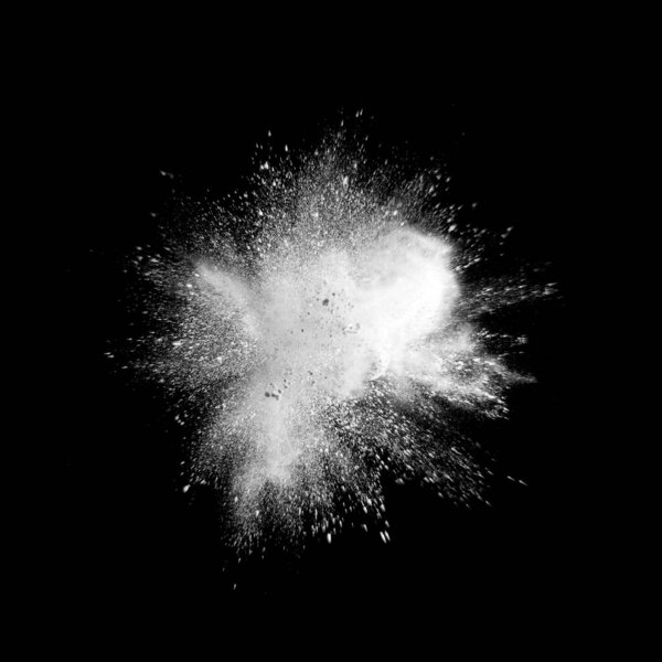 Explosion of white powder on a black background, isolated .