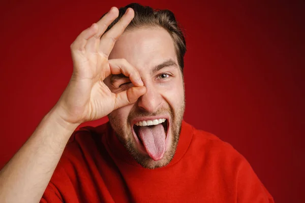 Young Bristle Man Wearing Sweater Gesturing While Showing His Tongue — Stock Photo, Image
