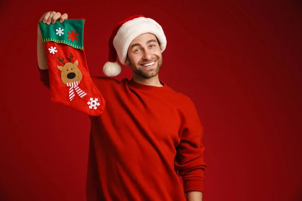 Young Man Wearing Santa Hat Smiling While Posing Christmas Sock — ストック写真