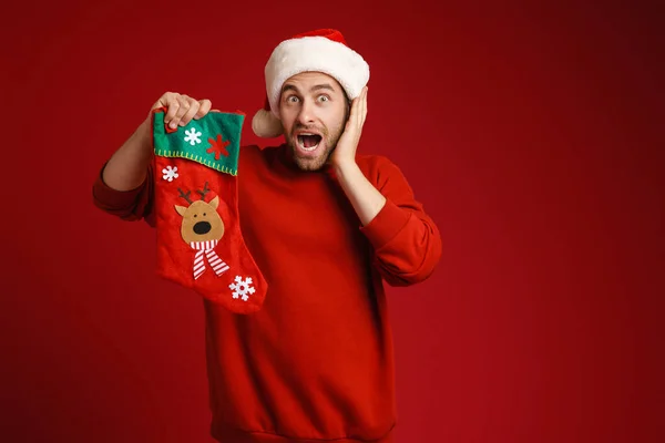 Young Shocked Man Wearing Santa Hat Posing Christmas Sock Isolated — Stock Photo, Image