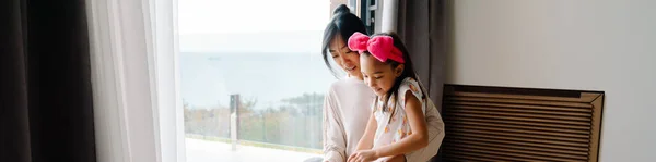 Asian Woman Her Daughter Talking While Standing Window Together Home — Stockfoto