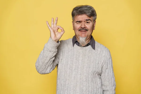 Senior Grey Man Winking Showing Sign Camera Isolated Yellow Background — Stock Photo, Image
