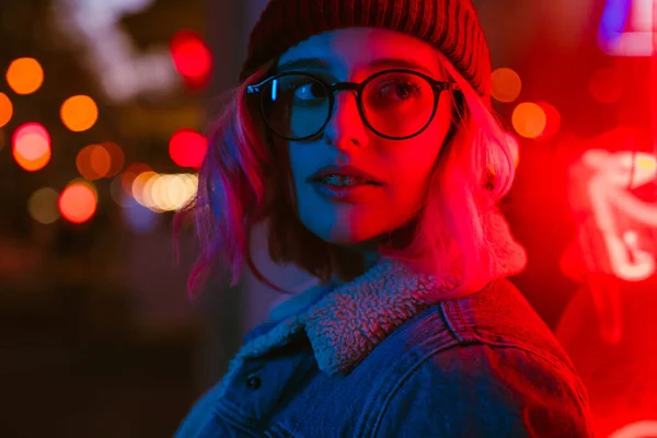 stock image Young white woman in eyeglasses looking aside on city street