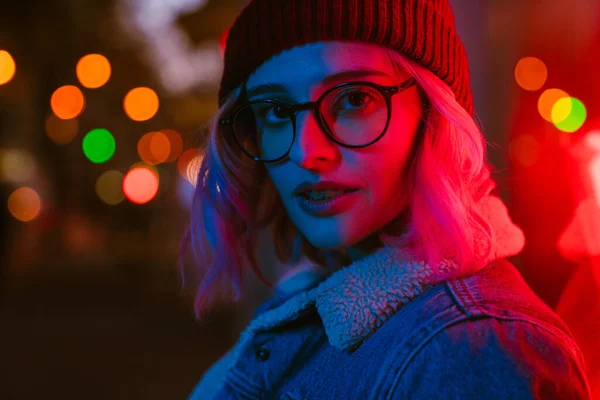 stock image Young white woman in eyeglasses looking at camera on city street