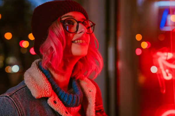 stock image Young white woman in eyeglasses smiling and looking at camera on city street