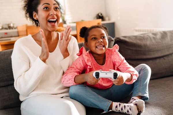 Afrikaans Amerikaanse Vrouw Klein Meisje Zitten Bank Spelen Video Game — Stockfoto