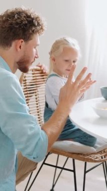 Mutfakta parmaklarına güvenen pozitif baba ve kız.