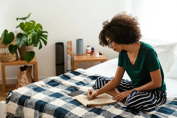 African American Young Woman Curly Hairstyle Sitting Bed Drawing Sketchbook — Stock Photo, Image